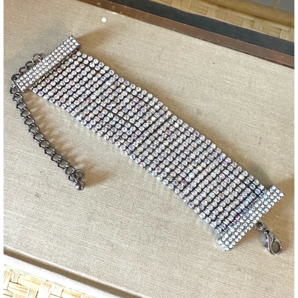 Wide, multi-row clear rhinestone bracelet with a dark-tone metal setting